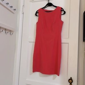 Bright coral, form-fitting, mini dress. Stretchy material.
